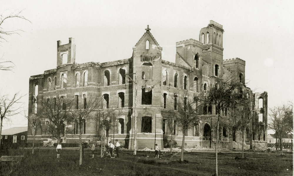 The charred remains of a four-story stone building, ɫ's Waco campus main building after a fire