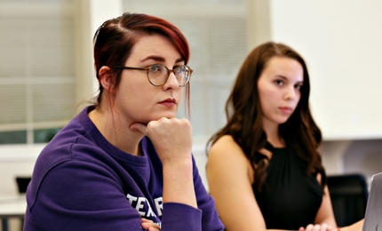 Two graduate students listen intently in an education class at ɫ