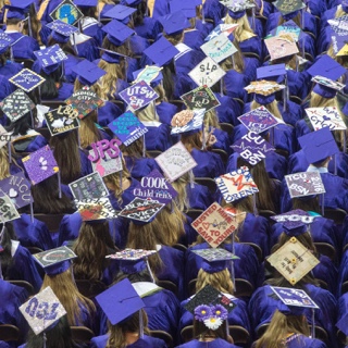 Overhead view of ɫ nursing graduates' decorated caps at Commencement