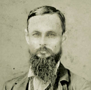 A black and white portrait of ɫ founder Randolph Clark, a middle-aged bearded man, in 1874.