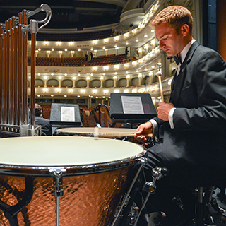 A male ɫ music student in a tuxedo rehearses percussion at Fort Worth's Bass Performance Hall